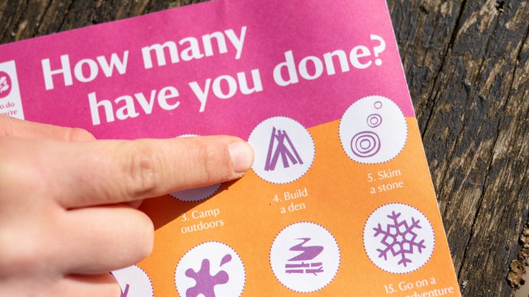 Child pointing out den building activity - 50 things